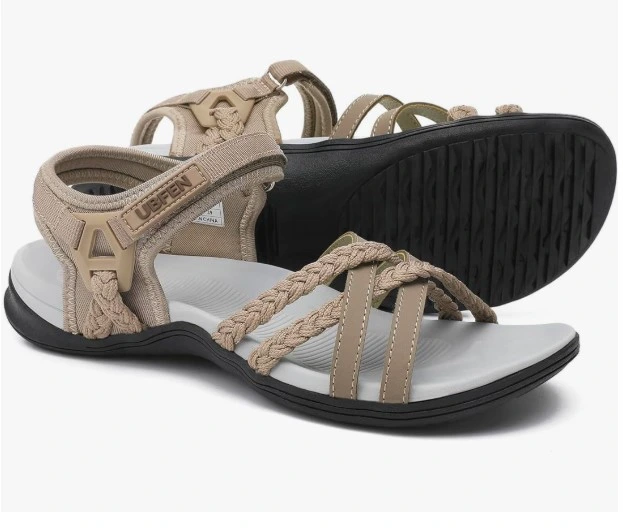 Meet your new go-everywhere sandal. The UBFEN Braided Sport Sandal in beige is built for women who refuse to choose between comfort and style. Whether you're hitting a farmers market, a beach boardwalk, or a casual hike — this sandal does it all.  The braided rope toe straps give it a relaxed, effortless look while the adjustable velcro ankle strap locks in a secure fit. The thick rubber outsole with deep treads means you're stable on any surface. No slipping. No sore feet. Just confidence.  Braided multi-strap toe design in warm beige Adjustable velcro ankle closure for a custom fit Thick ridged rubber outsole for grip and durability Cushioned footbed for all-day wear Perfect for: Beach trips, outdoor markets, travel days, casual summer outings.