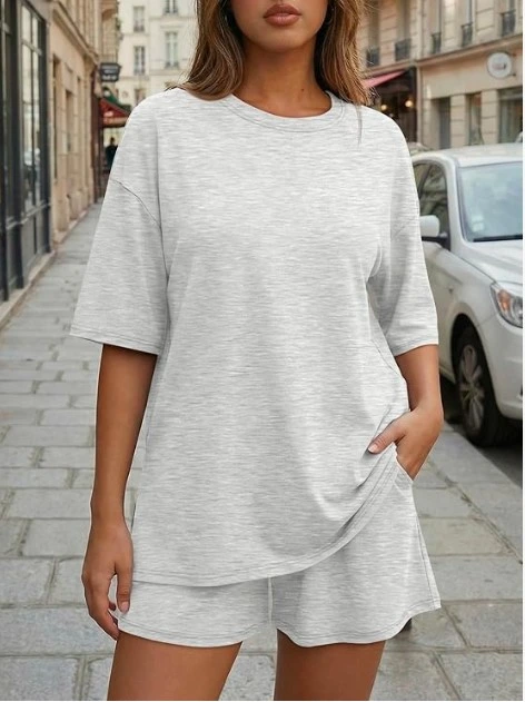 This women's two-piece lounge set in light heathered grey includes a relaxed crewneck tee with short sleeves and matching shorts — both featuring side pockets. The fabric has a soft, casual feel that looks polished enough to wear outside but comfortable enough to lounge in all day. The model is styled on a Parisian-style street, proving that this set is far from boring. It's the kind of outfit that makes you look put-together with zero effort. Why you'll love it: Matching set takes the guesswork out of getting dressed Side pockets on both pieces — a total win Heathered grey color goes with everything Perfect for travel, errands, and lazy-chic days out Shop On Amazon